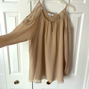 Blouse by Calvin Klein with cutout long sleeve shoulder.